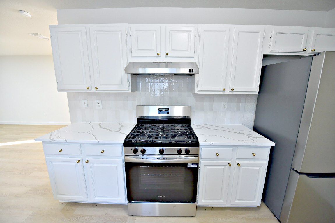 4617 Sidereal Drive Austin, TX 78727 - Photo 13 of 23 a stove top oven sitting inside of a kitchen