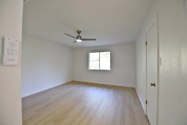 wooden floor in an empty room with a window