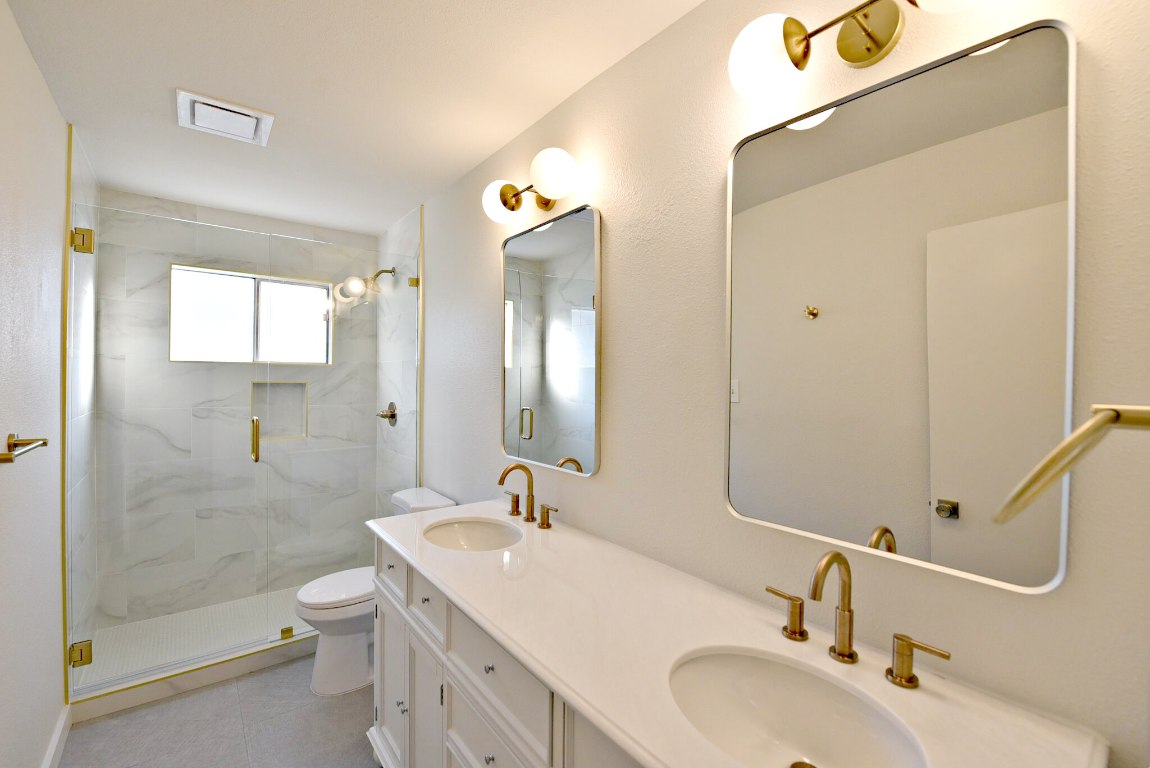 4617 Sidereal Drive Austin, TX 78727 - Photo 17 of 23 a bathroom with a sink a toilet and shower