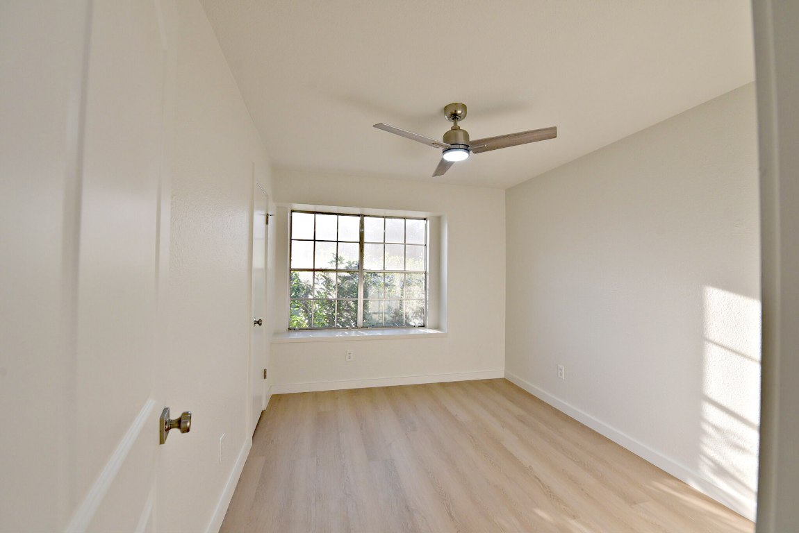 4617 Sidereal Drive Austin, TX 78727 - Photo 19 of 23 an empty room with a window and a ceiling fan
