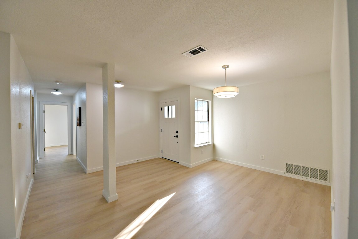 4617 Sidereal Drive Austin, TX 78727 - Photo 5 of 23 an empty room with wooden floor and windows