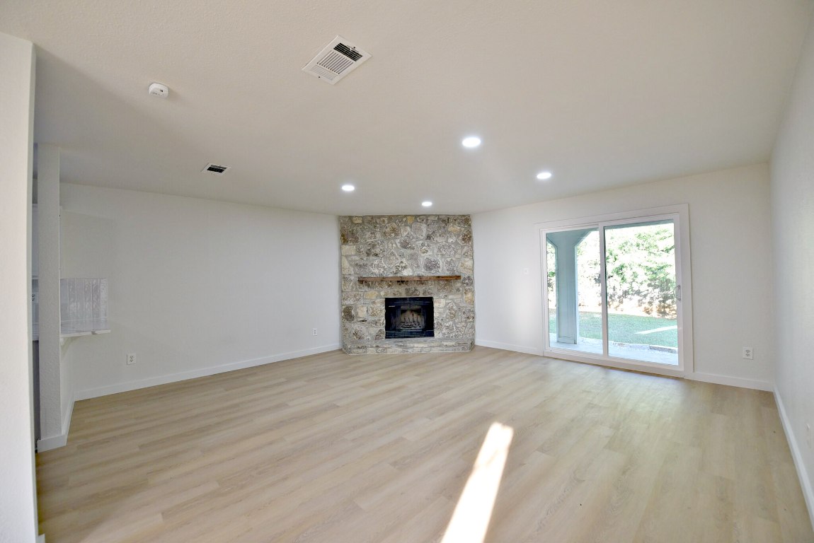 4617 Sidereal Drive Austin, TX 78727 - Photo 6 of 23 a view of an empty room with a window and fireplace