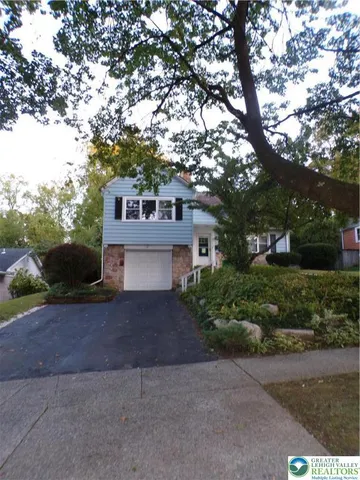 a house that has tree in front of it