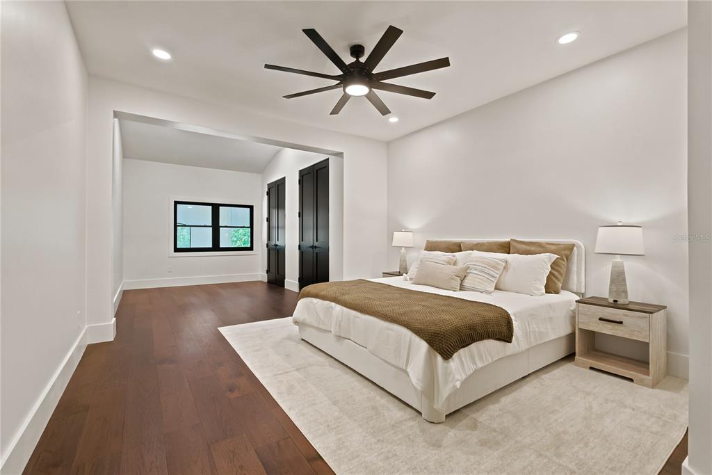 9725 Chestnut Ridge Drive Windermere, FL 34786 - Photo 45 of 64 a bedroom with a large bed and a chandelier