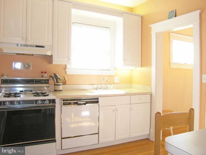 2030 Glen Ross Road Silver Spring, MD 20910 - Photo 16 of 23 a kitchen with a stove and a white cabinet