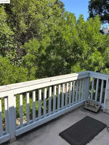 a view of a chair and table in the balcony