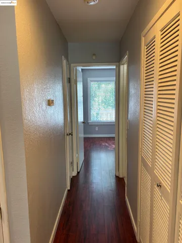 a view of a hallway with wooden floor