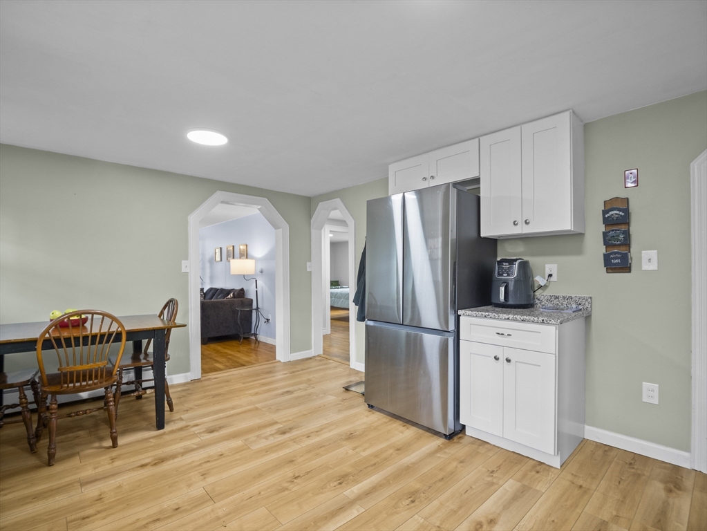 354 Townsend Road Groton, MA 01450 - Photo 21 of 39 a kitchen with a refrigerator and a dining table