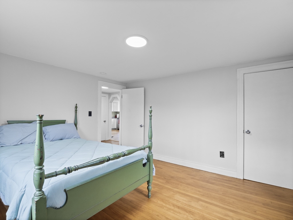 354 Townsend Road Groton, MA 01450 - Photo 29 of 39 a bedroom with a bed and wooden floor