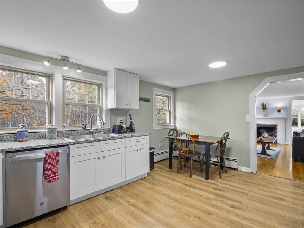 354 Townsend Road Groton, MA 01450 - Photo 3 of 39 a kitchen with a sink cabinets and dining table chair