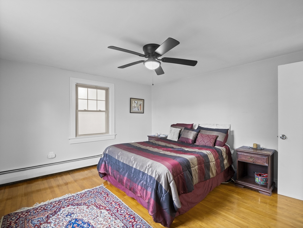 354 Townsend Road Groton, MA 01450 - Photo 32 of 39 a bedroom with a bed chandelier and a window