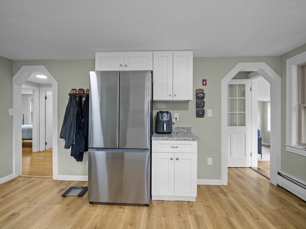 354 Townsend Road Groton, MA 01450 - Photo 4 of 39 a kitchen with a refrigerator and a wooden floor