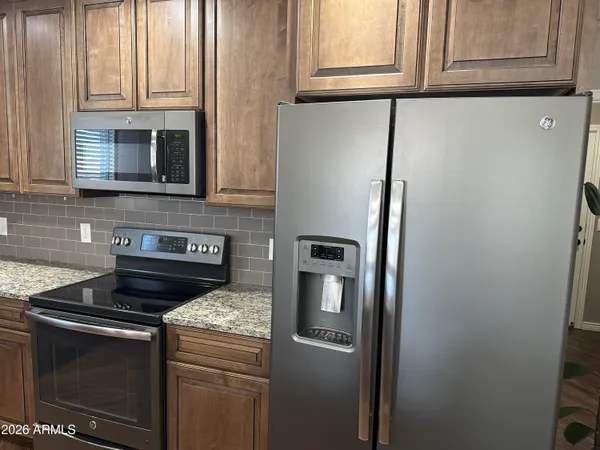 a kitchen with granite countertop cabinets and steel stainless steel appliances