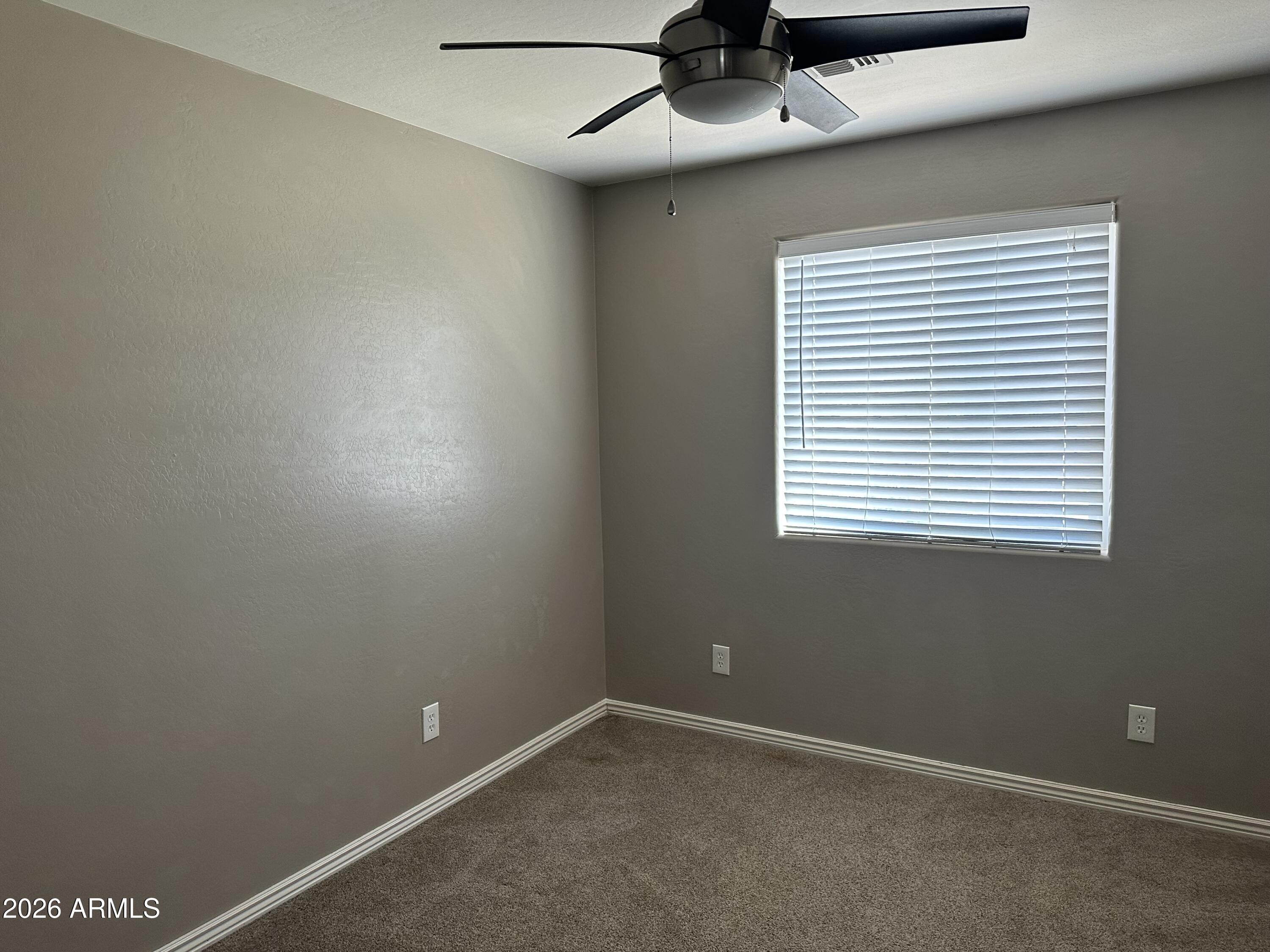 1059 West 5th Avenue Apache Junction, AZ 85120 - Photo 6 of 14 an empty room with a window