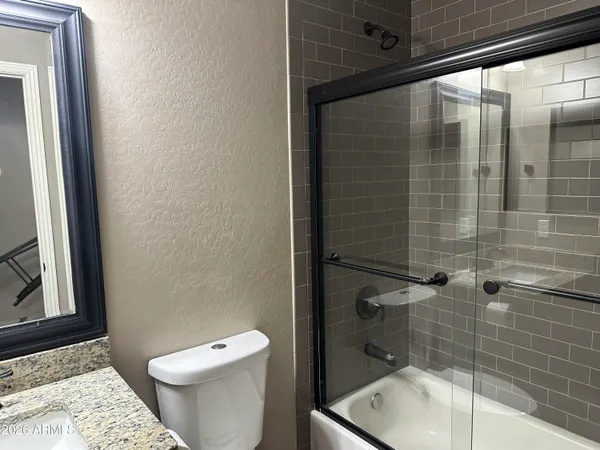 a bathroom with a toilet a sink and shower