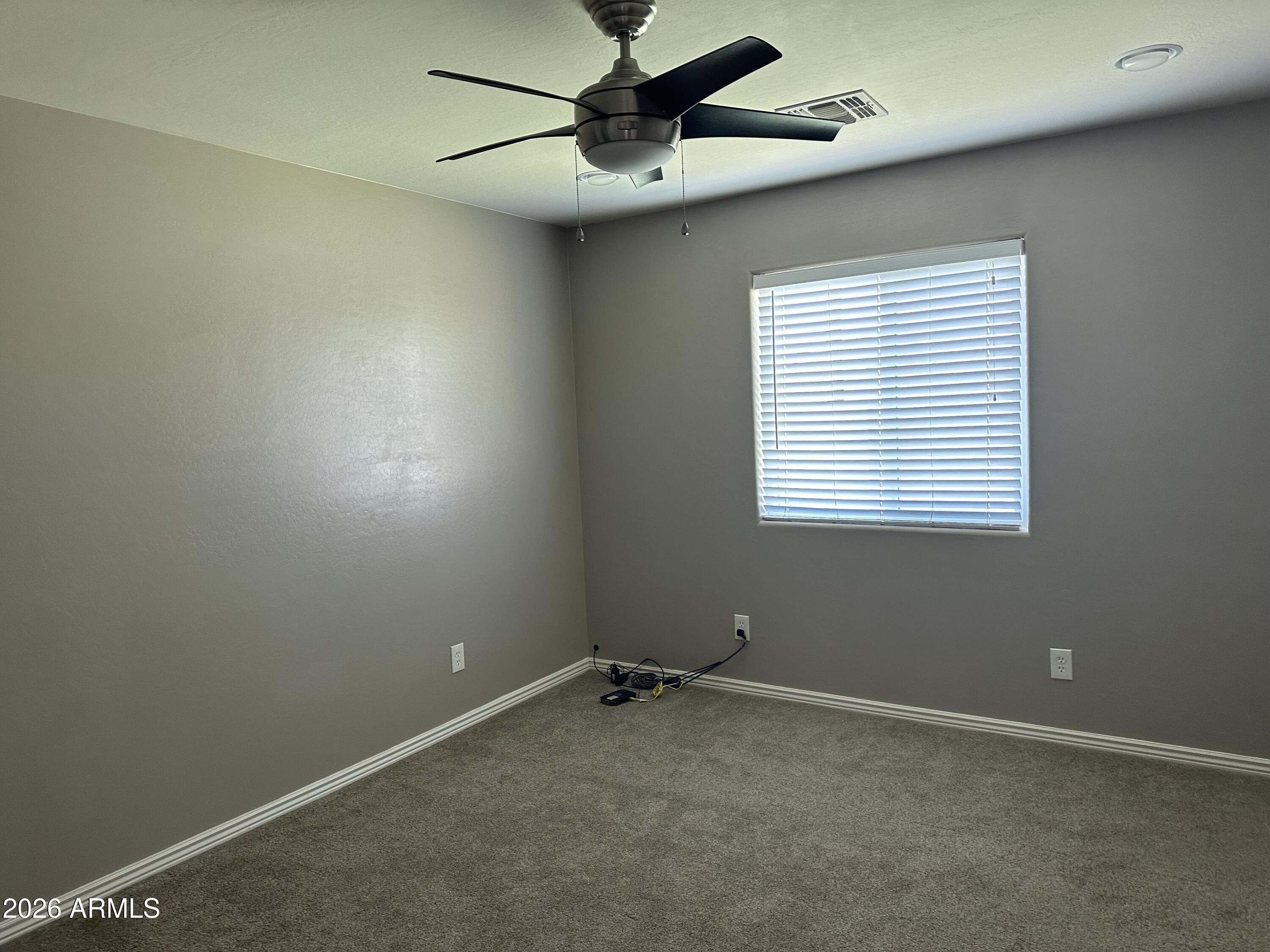 1059 West 5th Avenue Apache Junction, AZ 85120 - Photo 9 of 14 a view of a room with a ceiling fan and a window