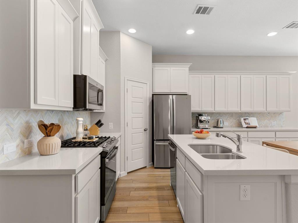 166 Palo Duro Bend Rhome, TX 76078 - Photo 13 of 40 Kitchen with generous workspace, storage, and seamless flow to the main living areas.