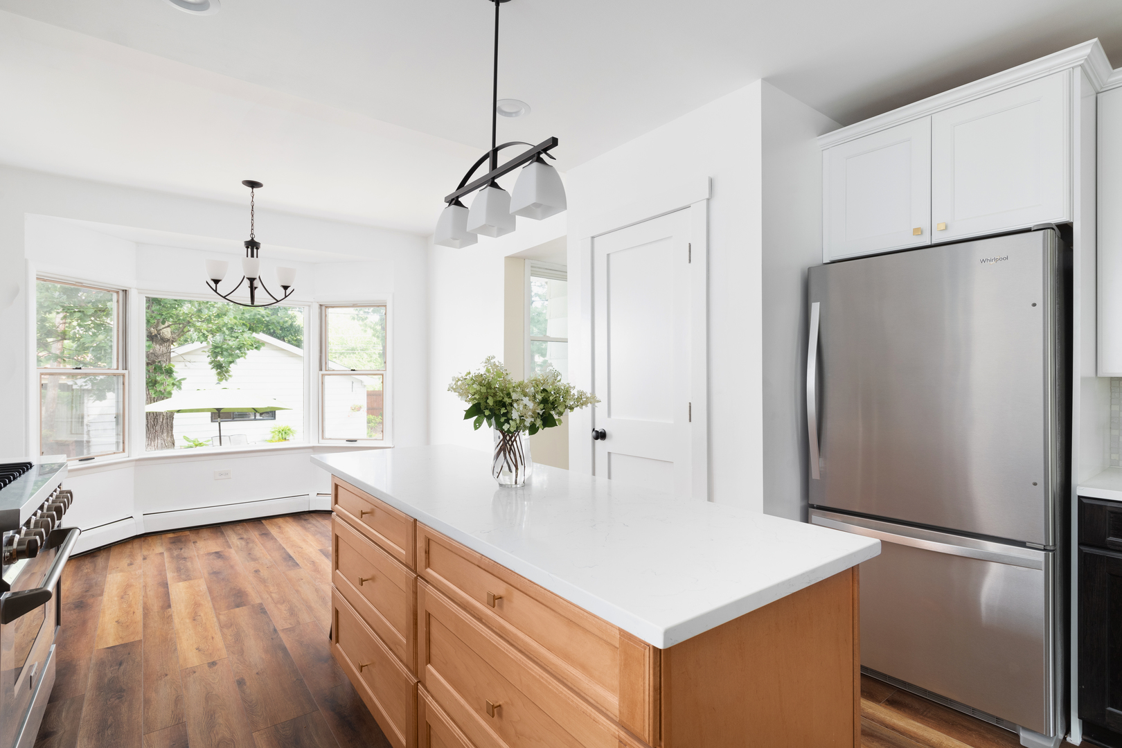 294 Maplewood Road Riverside, IL 60546 - Photo 7 of 31 a kitchen with stainless steel appliances a refrigerator a sink and wooden floors