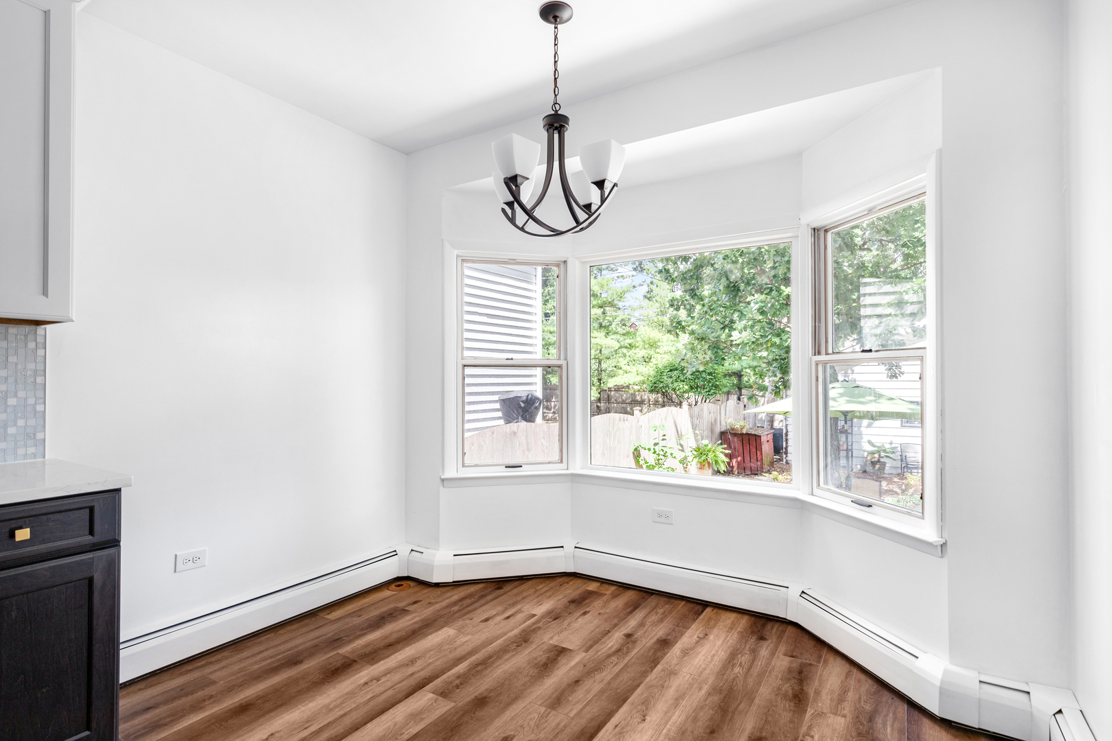 294 Maplewood Road Riverside, IL 60546 - Photo 9 of 31 a view of an empty room with wooden floor and windows