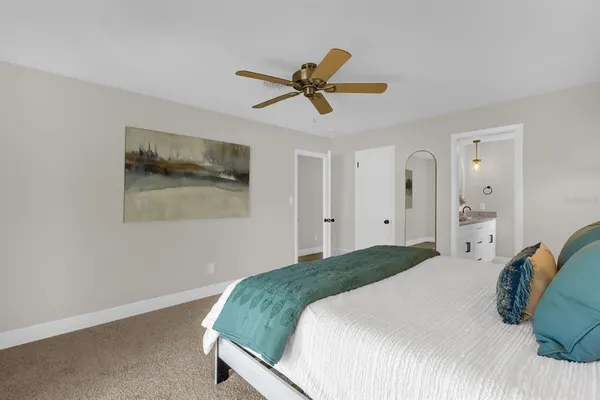 a bedroom with a bed and a painting