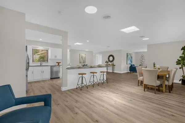 a living room with furniture and view of kitchen