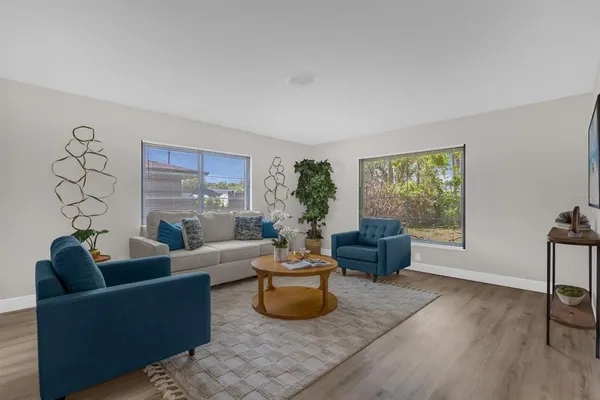 a living room with furniture and a large window