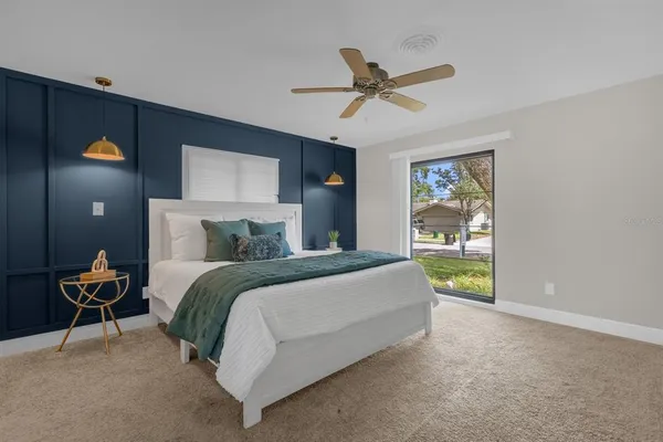 a bedroom with a bed and a chandelier
