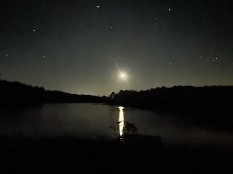 a sunset view with a lake