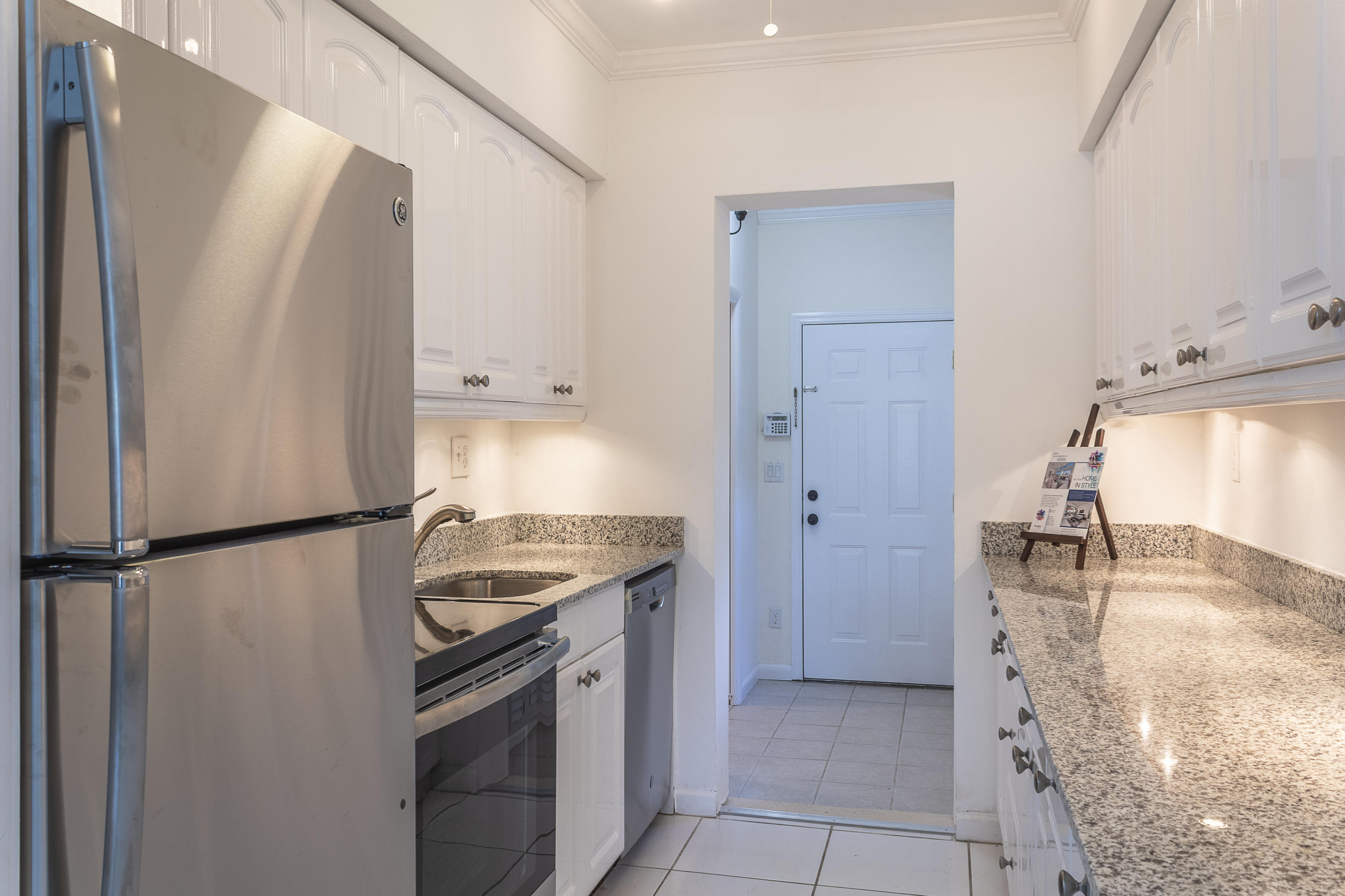 770 East Camino Real, Unit 60 Boca Raton, FL 33432 - Photo 11 of 40 a kitchen with a refrigerator and a sink