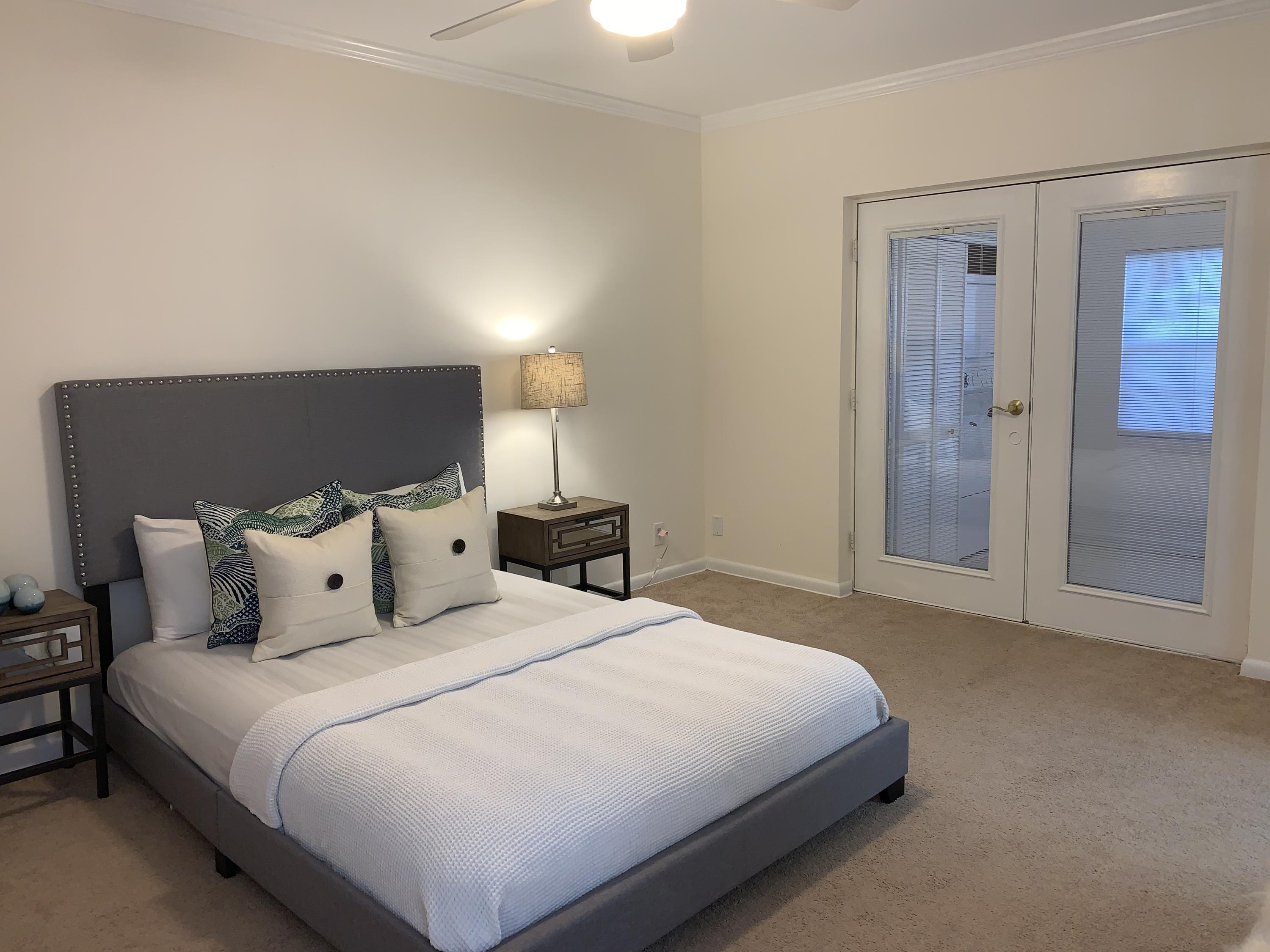 770 East Camino Real, Unit 60 Boca Raton, FL 33432 - Photo 13 of 40 a bedroom with a bed and a night stand