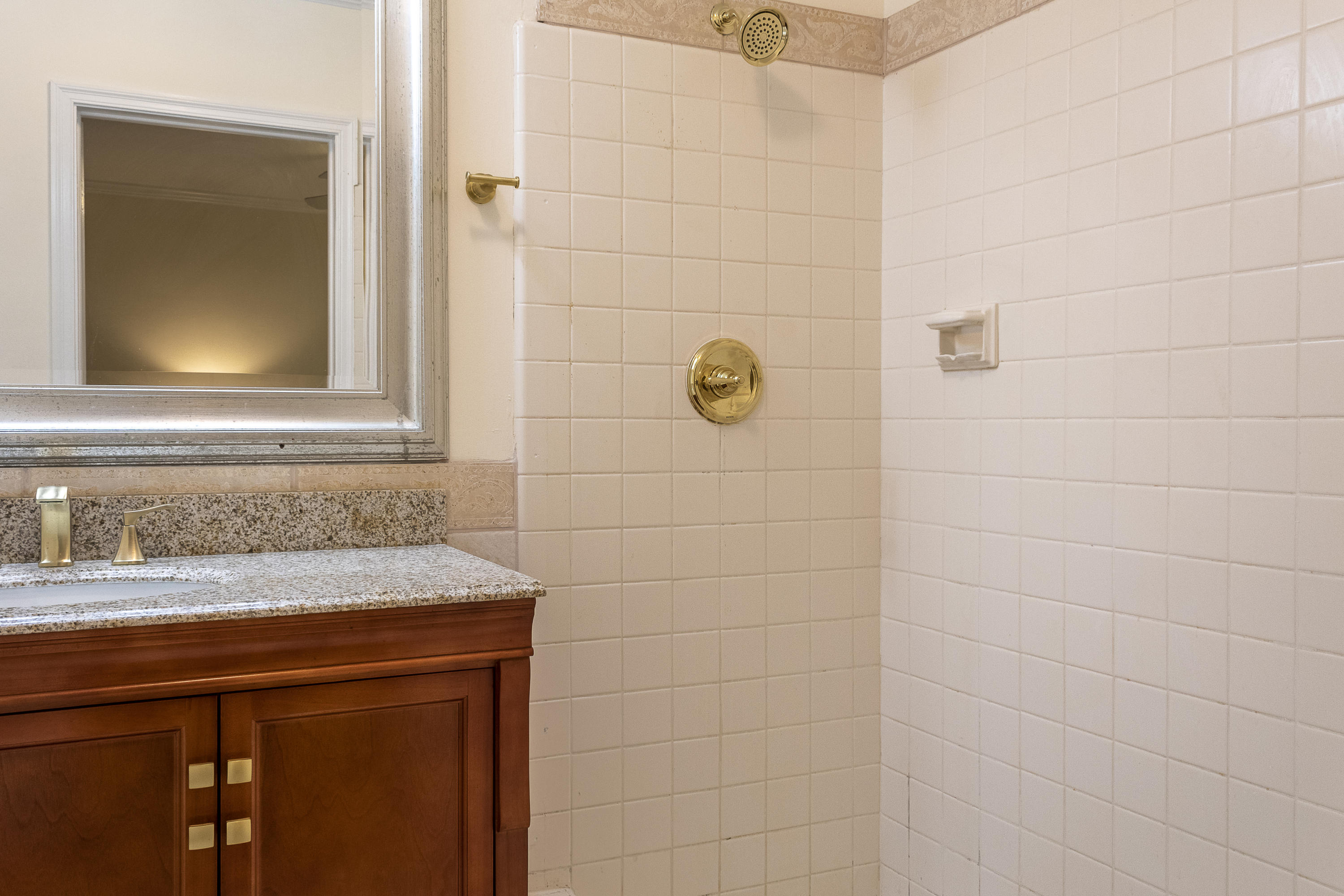 770 East Camino Real, Unit 60 Boca Raton, FL 33432 - Photo 19 of 40 a bathroom with a sink and a mirror