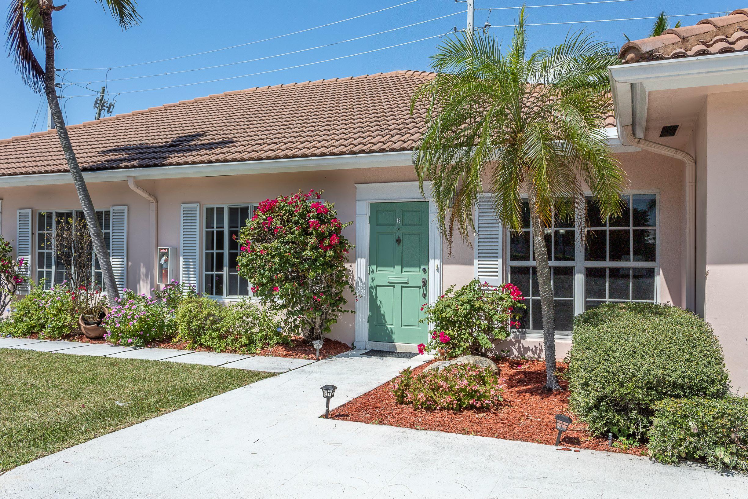 770 East Camino Real, Unit 60 Boca Raton, FL 33432 - Photo 2 of 40 a front view of a house with garden