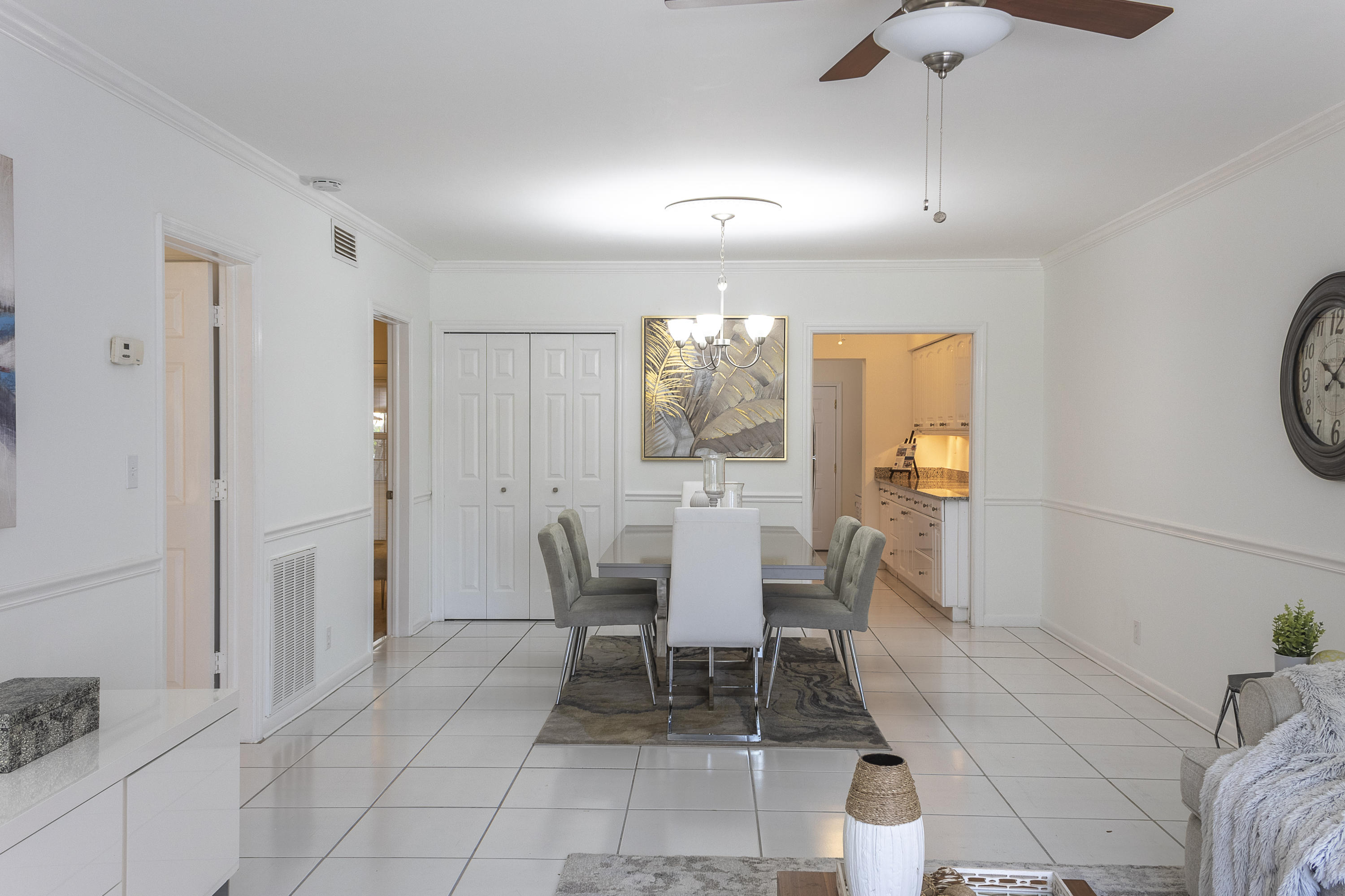 770 East Camino Real, Unit 60 Boca Raton, FL 33432 - Photo 5 of 40 a dining room with furniture and a chandelier fan