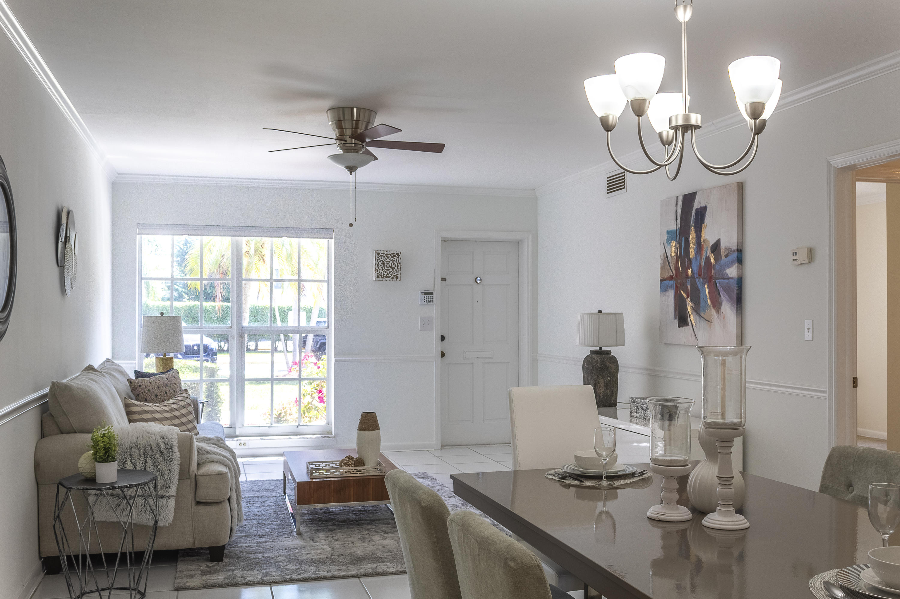 770 East Camino Real, Unit 60 Boca Raton, FL 33432 - Photo 7 of 40 a living room with furniture chandelier and a window