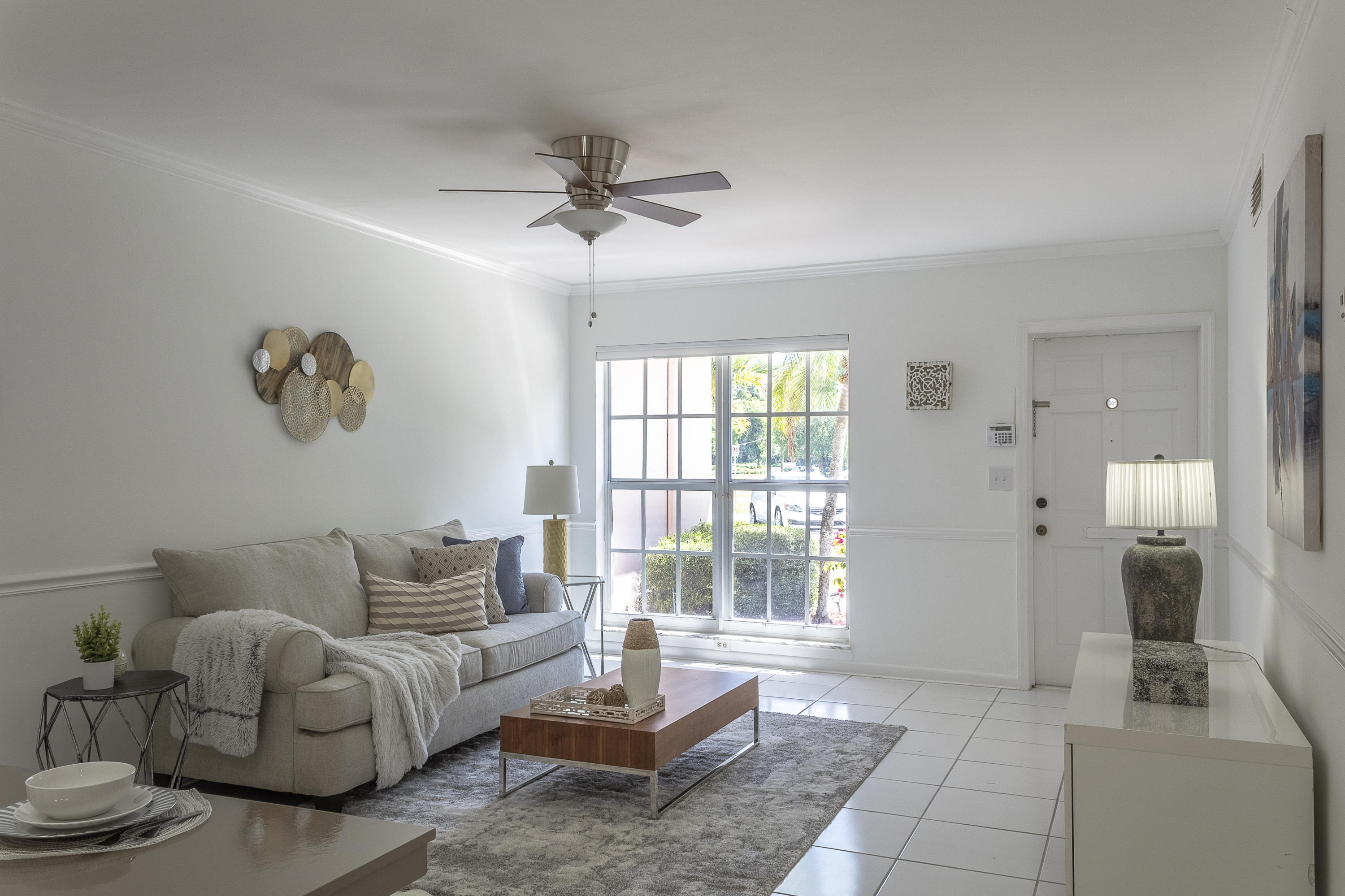 770 East Camino Real, Unit 60 Boca Raton, FL 33432 - Photo 8 of 40 a living room with furniture and a large window
