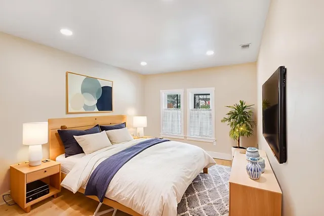 a bedroom with a bed and a flat screen tv