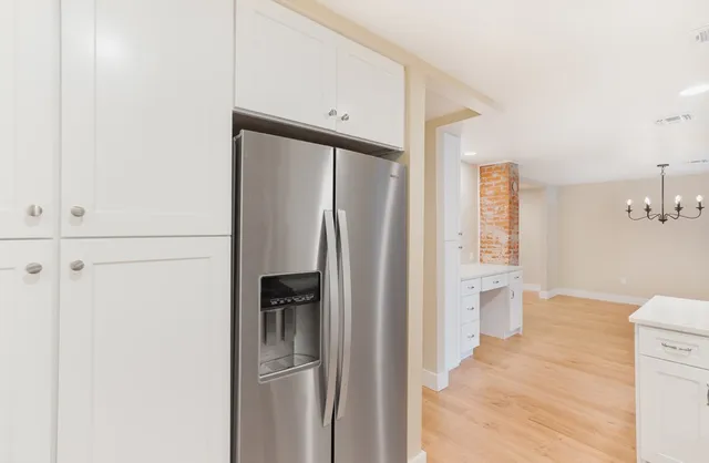 a kitchen with stainless steel appliances a refrigerator and cabinets