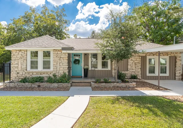 a view of house with swimming pool outdoor seating