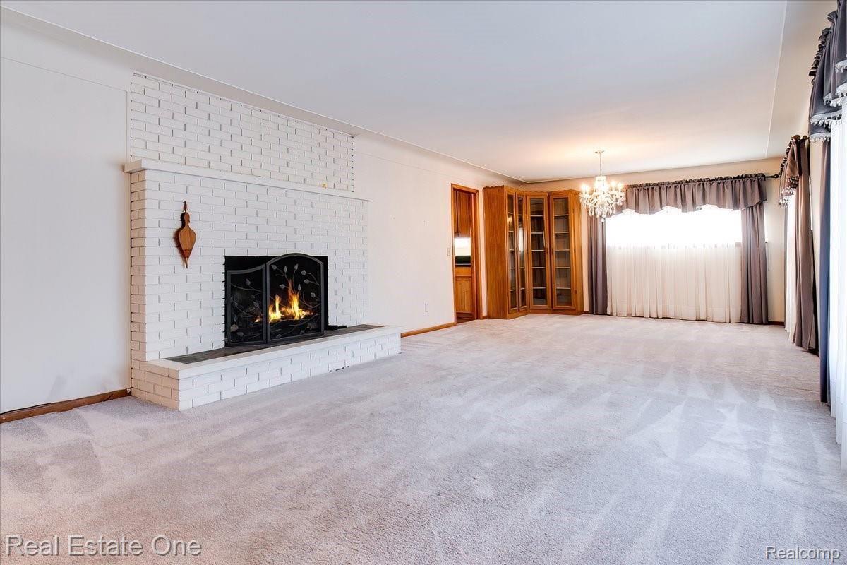 1730 Morley Avenue Rochester, MI 48307 - Photo 6 of 41 ;Huge Living / Dining room with a gas fireplace, hardwood floors under all carpeting