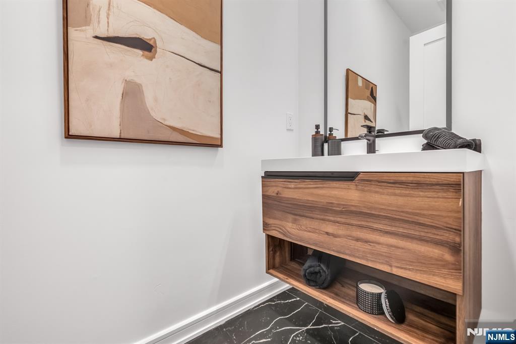 23 Fey Place Oradell, NJ 07649 - Photo 12 of 36 a bathroom with a sink and a mirror