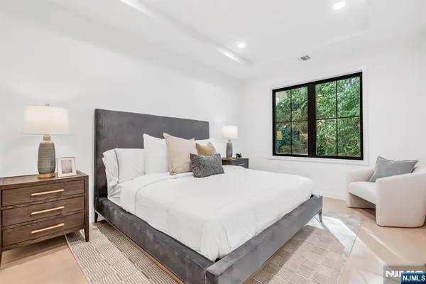a bedroom with a bed and a large window