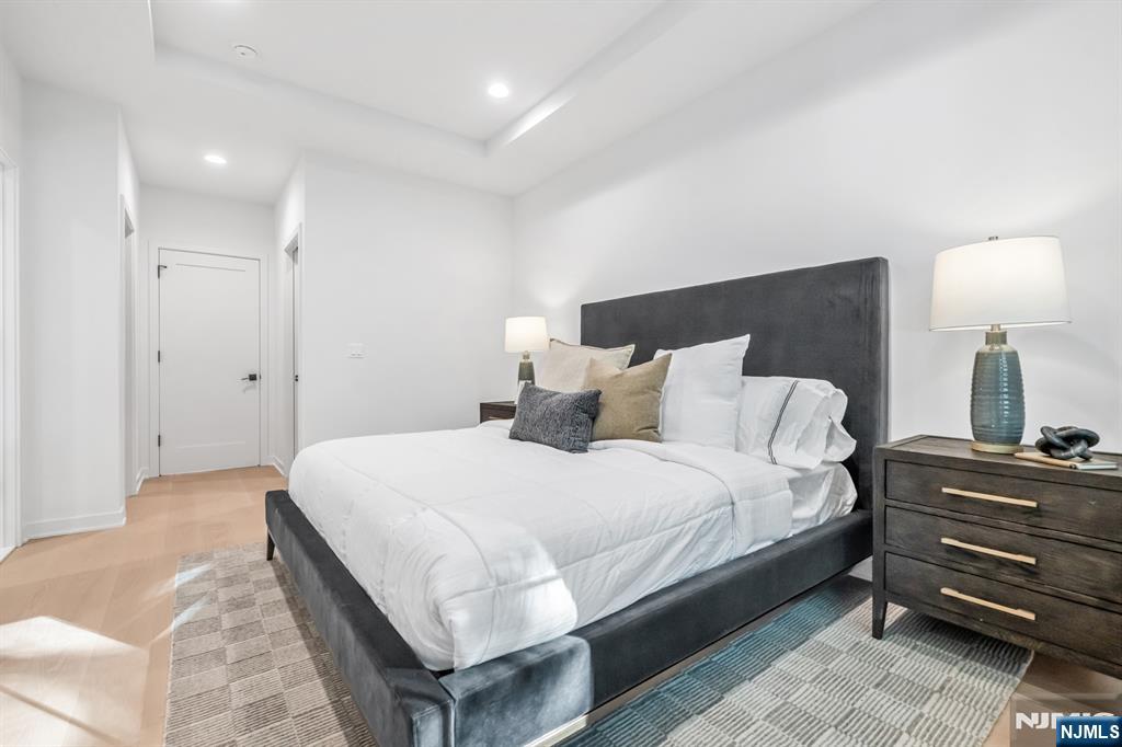 23 Fey Place Oradell, NJ 07649 - Photo 15 of 36 a bedroom with a bed and a lamp