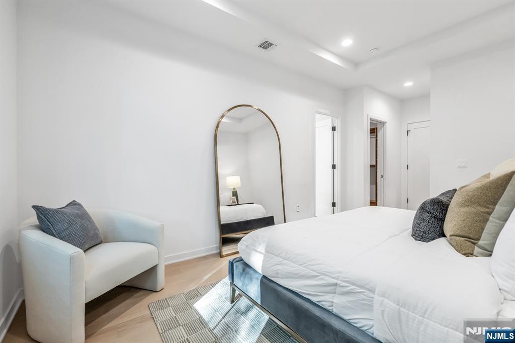 23 Fey Place Oradell, NJ 07649 - Photo 16 of 36 a bedroom with a bed a couch and a mirror