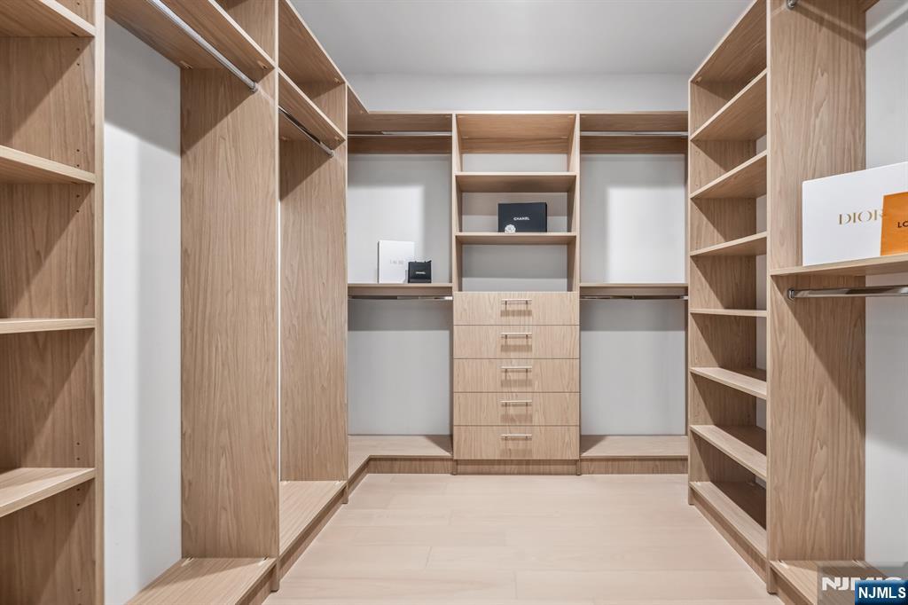 23 Fey Place Oradell, NJ 07649 - Photo 17 of 36 a view of walk in closet with clothes and shoes