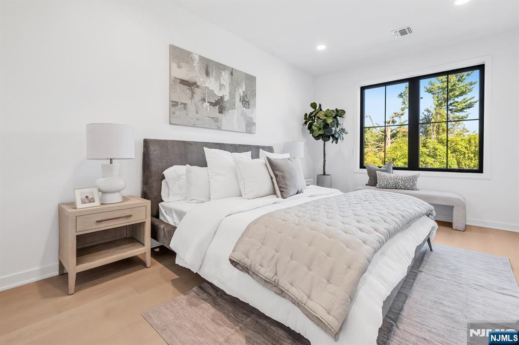 23 Fey Place Oradell, NJ 07649 - Photo 25 of 36 a bedroom with a bed and a painting on the wall