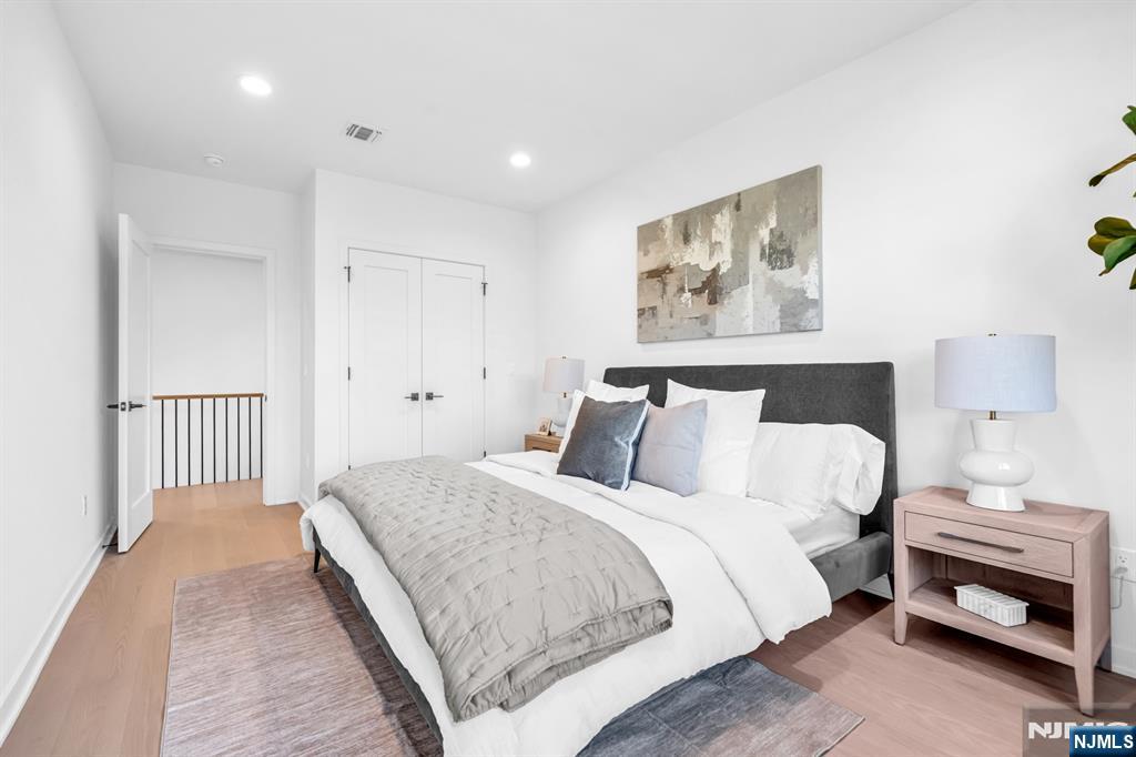 23 Fey Place Oradell, NJ 07649 - Photo 27 of 36 a bedroom with a bed and a painting on the wall