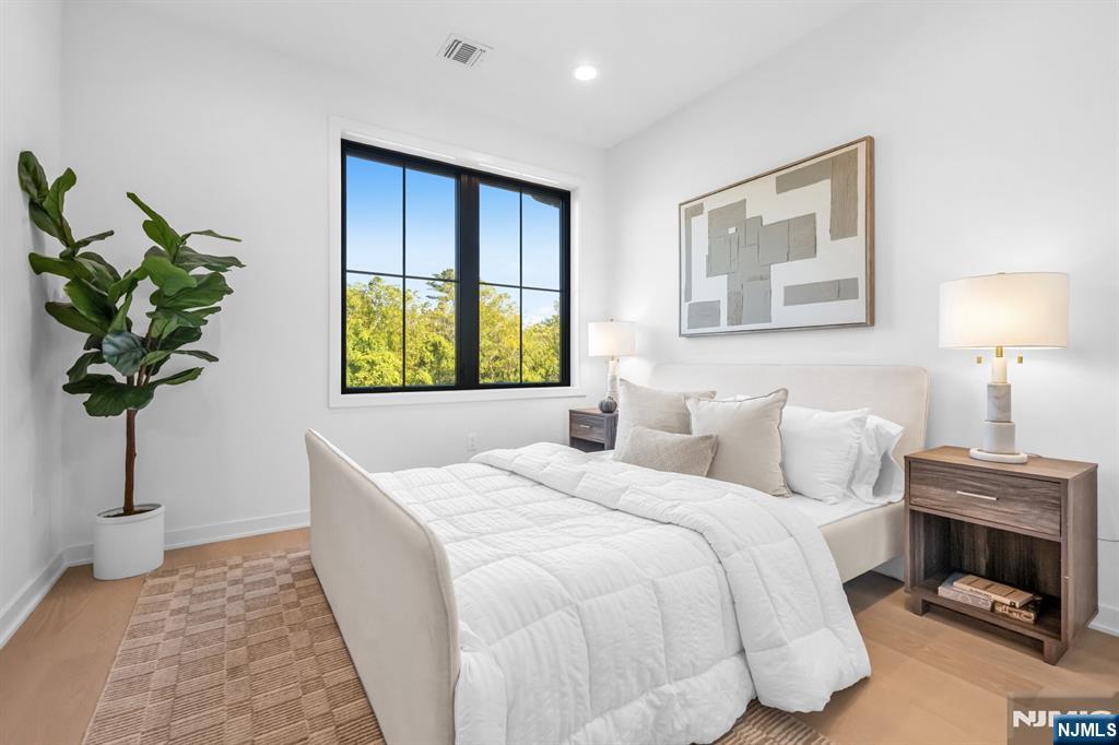 23 Fey Place Oradell, NJ 07649 - Photo 28 of 36 a bedroom with a bed and a potted plant