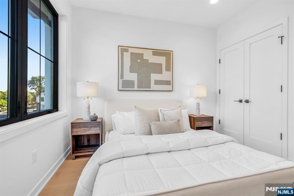 23 Fey Place Oradell, NJ 07649 - Photo 29 of 36 a bedroom with a bed and a painting on the wall