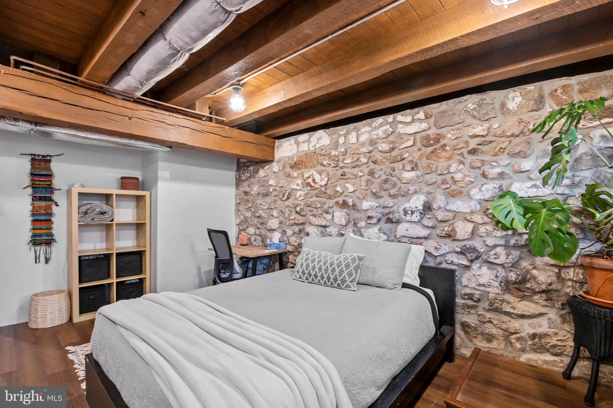 248 Warwick Road Elverson, PA 19520 - Photo 32 of 56 Lower level bedroom with exposed beam ceiling