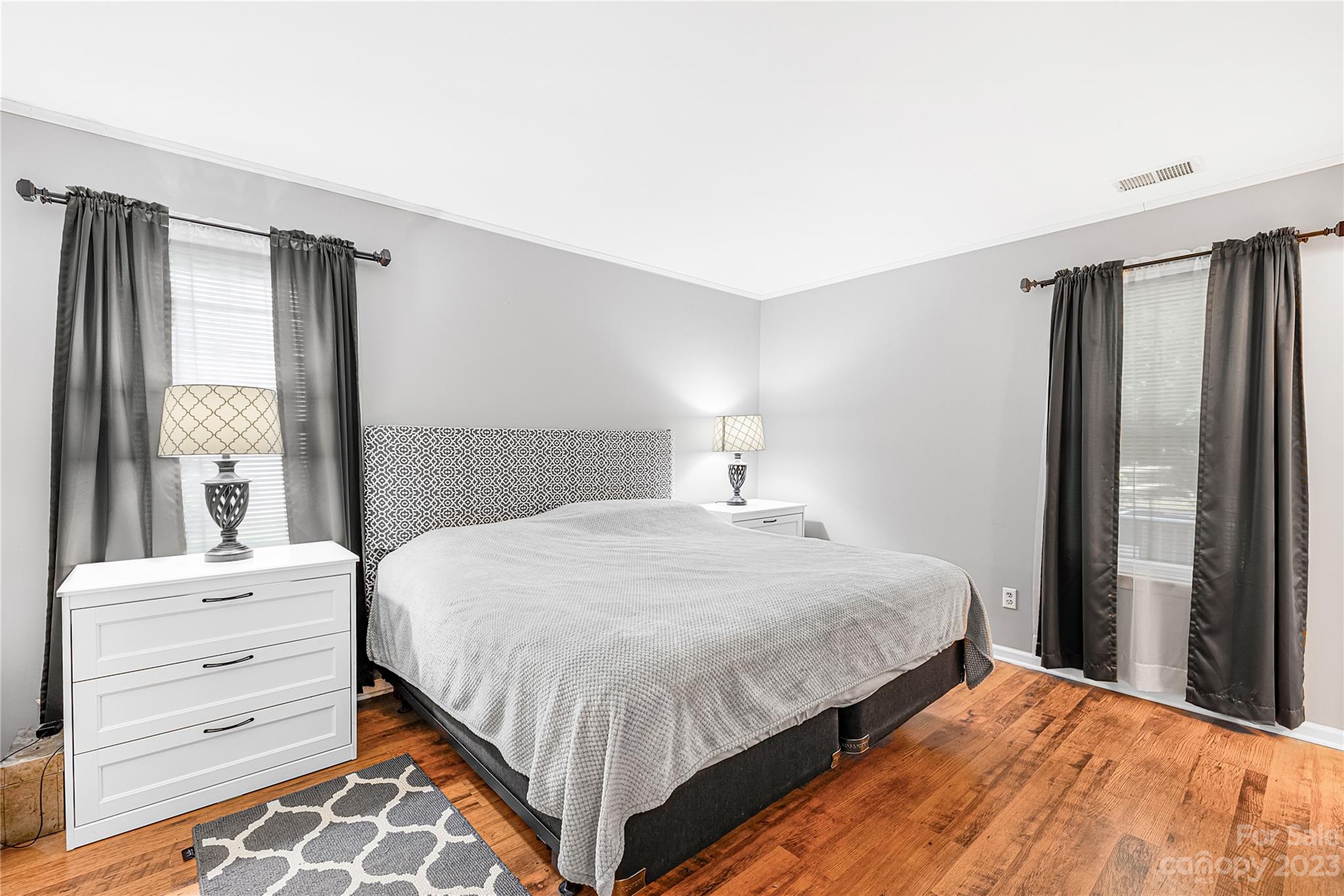 9504 Foggy Meadow Road Charlotte, NC 28269 - Photo 12 of 24 a bedroom with a bed and large window